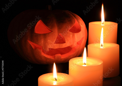 Jack O' Lantern surrounded by candles