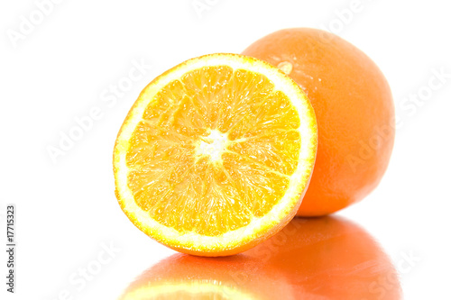 fresh oranges with mirroring  over white background