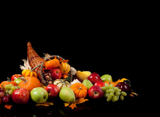 Fall arrangement of fruits and vegetables in a cornucopia