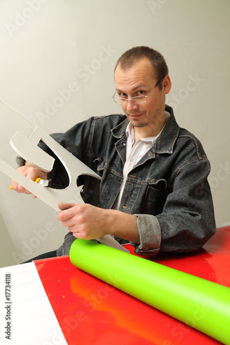 Adult male works in an advertising studio photo