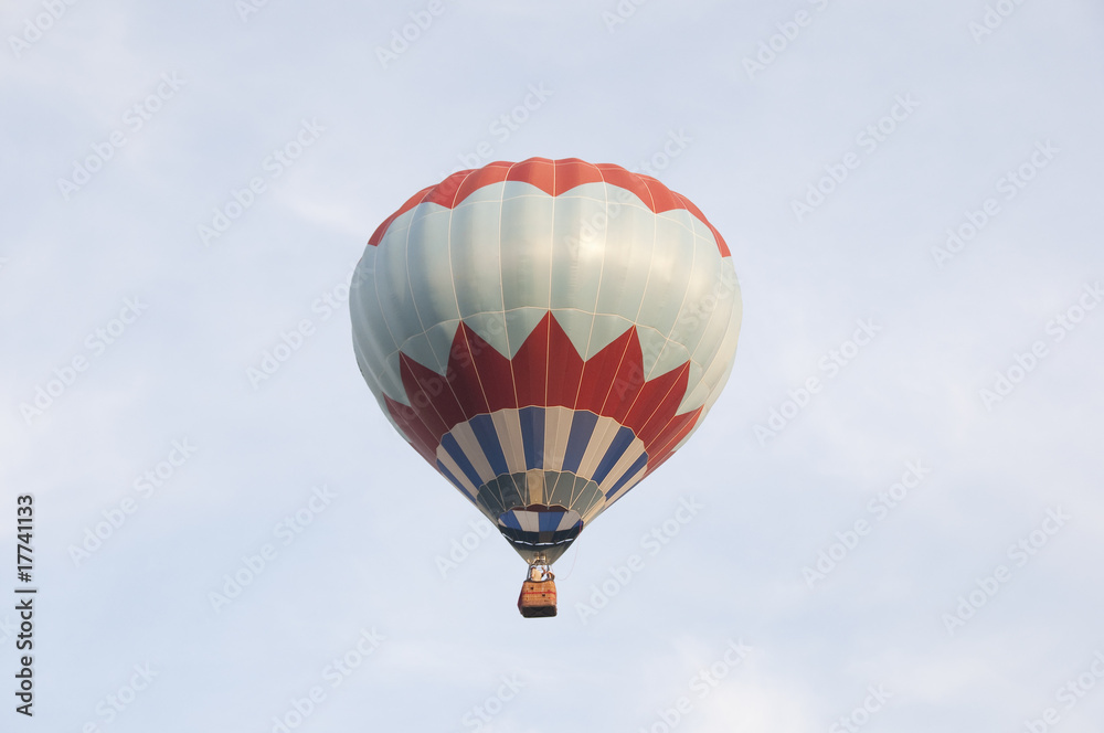 Fototapeta premium Colorful air balloon flies high in the sky