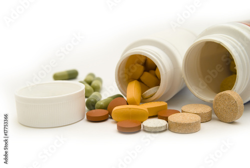 White bottles and pills macro, isolated