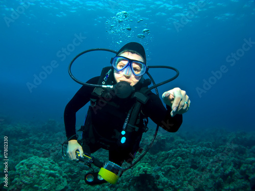 Female Scuba Diver swimming over a Reef in Kona Hawaii