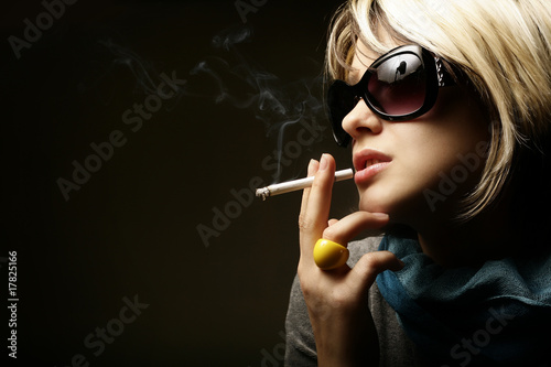 The beautiful girl smokes a cigarette