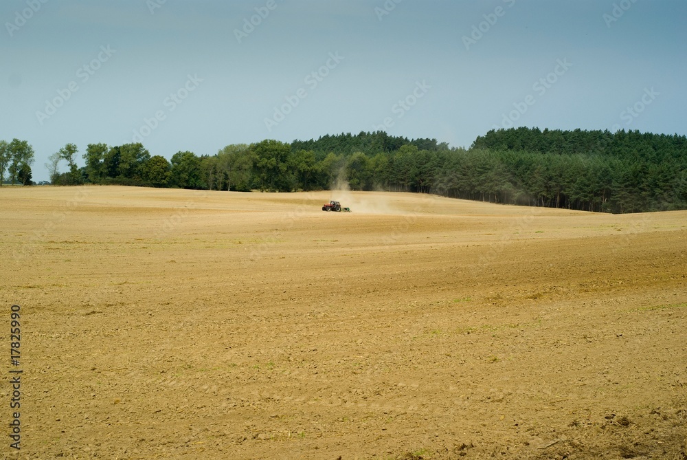 Obraz premium field with tractor at work