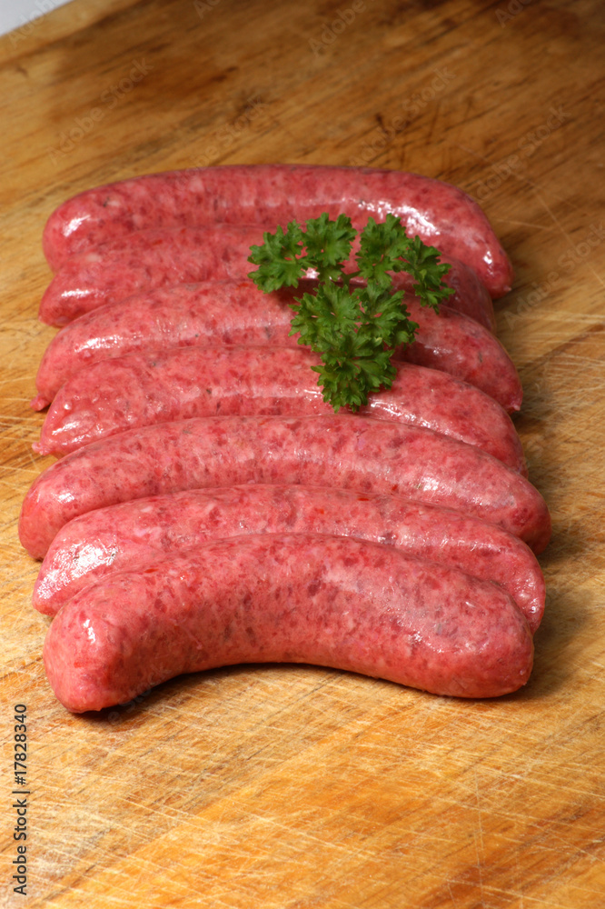 raw beef sausages on a timber board raw beef sausages on a timber board