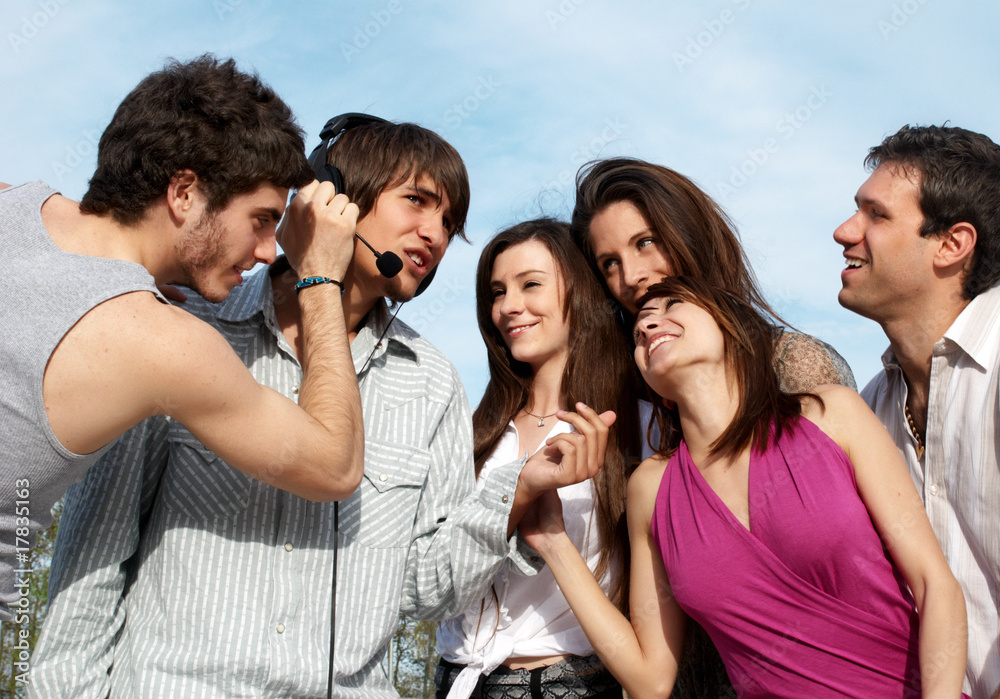 Group of young guys and girls having fun on the nature