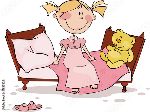 The little girl sits in the bed with a favourite toy