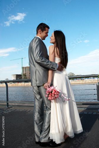 Newly-married couple against an under construction city © Andriy Petrenko