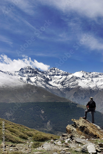 Male standing on top of mountain