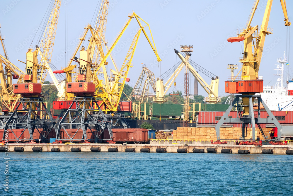 The trading seaport with cranes, cargoes and ship