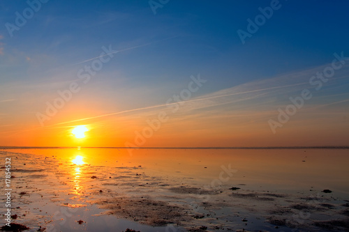 Sunrise at the sea coastline photo