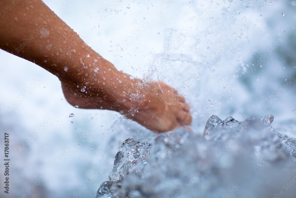 Fototapeta premium female leg under cold water