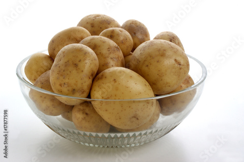 some potatoes in a glass bowl and white background