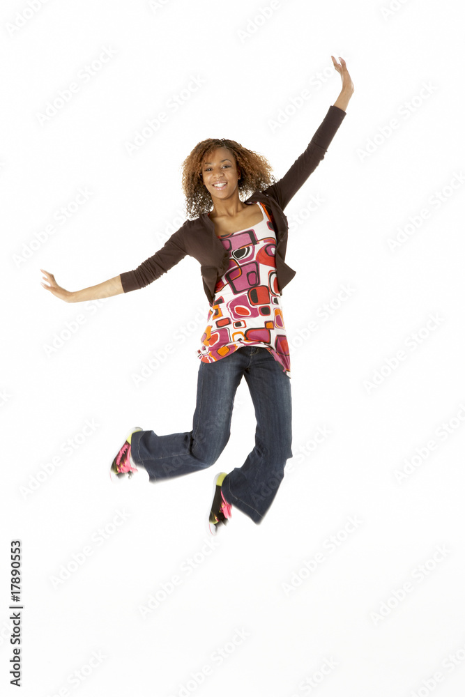 Full Length Studio Portrait Of Jumping Teenage Girl