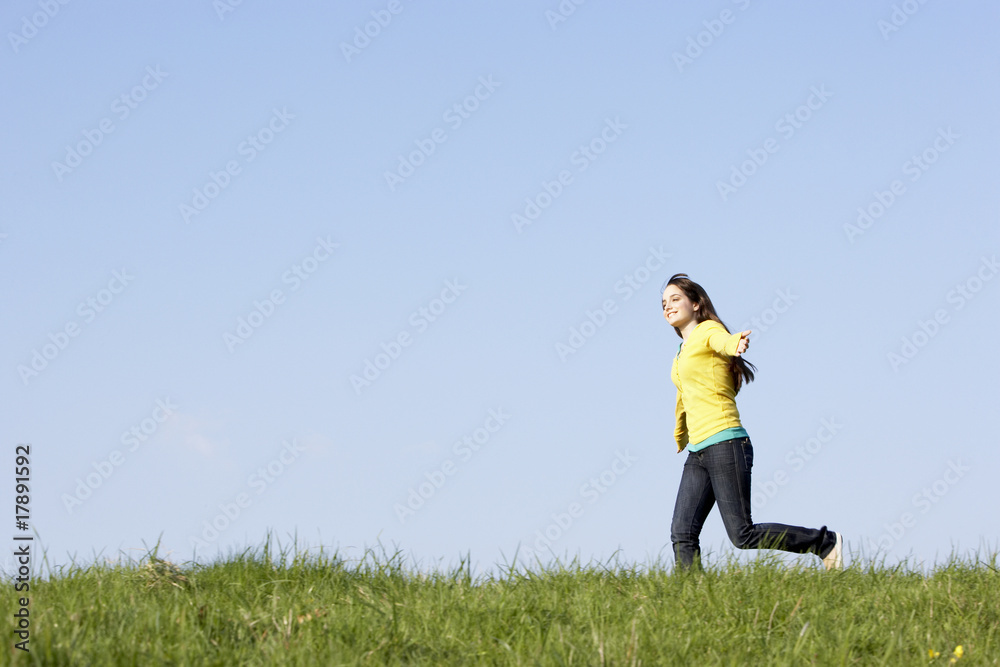 Teenage Girl Running Through Summer Meadow Teenage Girl Running Through Summer Meadow