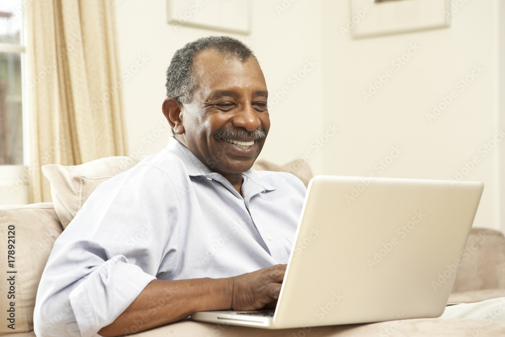 Senior Man Using Laptop At Home Senior Man Using Laptop At Home