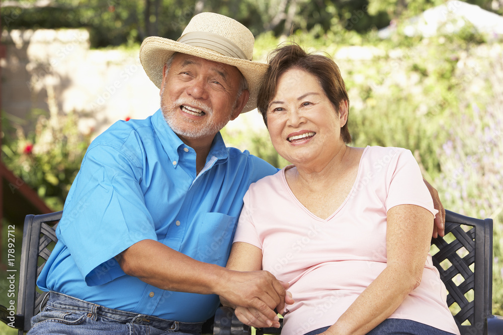Senior Couple Relaxing In Garden Together Senior Couple Relaxing In Garden Together