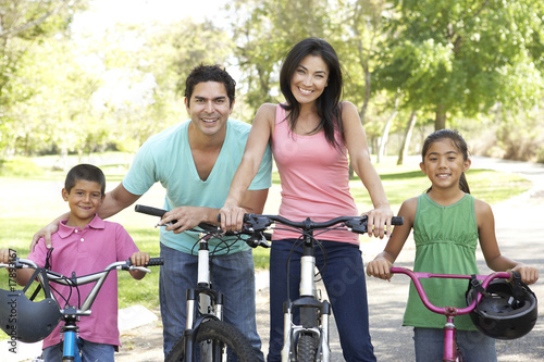Young Family Riding Bikes In Park © Monkey Business