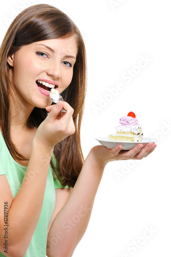 Beautiful happy young woman eating cake