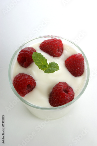 some organic raspberries in natural yoghurt and mint