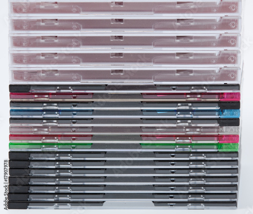 a blank dvd or cd with stack of empty cd cases on background photo