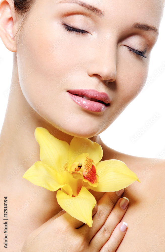 Pretty fresh clean female face with a flower Pretty fresh clean female face with a flower
