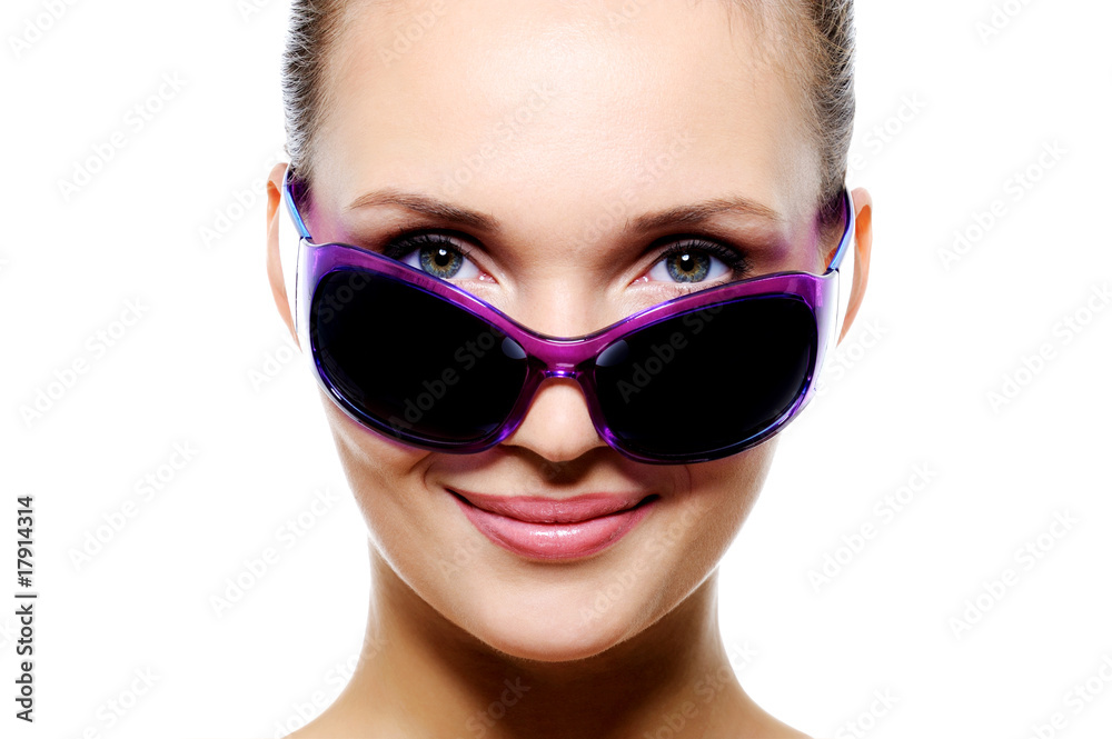Smiling woman face in dark violet sunglasses Smiling woman face in dark violet sunglasses