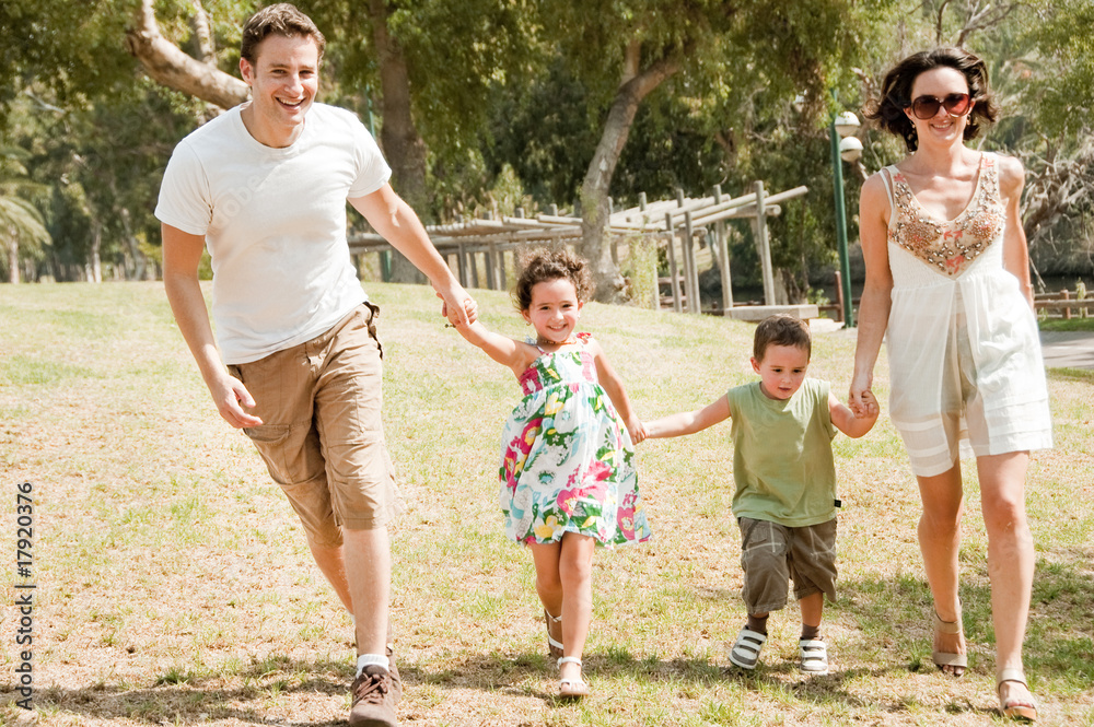 Fototapeta premium Family running with two young children