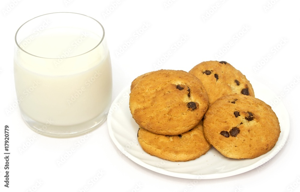glass of milk and cookies on a plate isolated on white glass of milk and cookies on a plate isolated on white