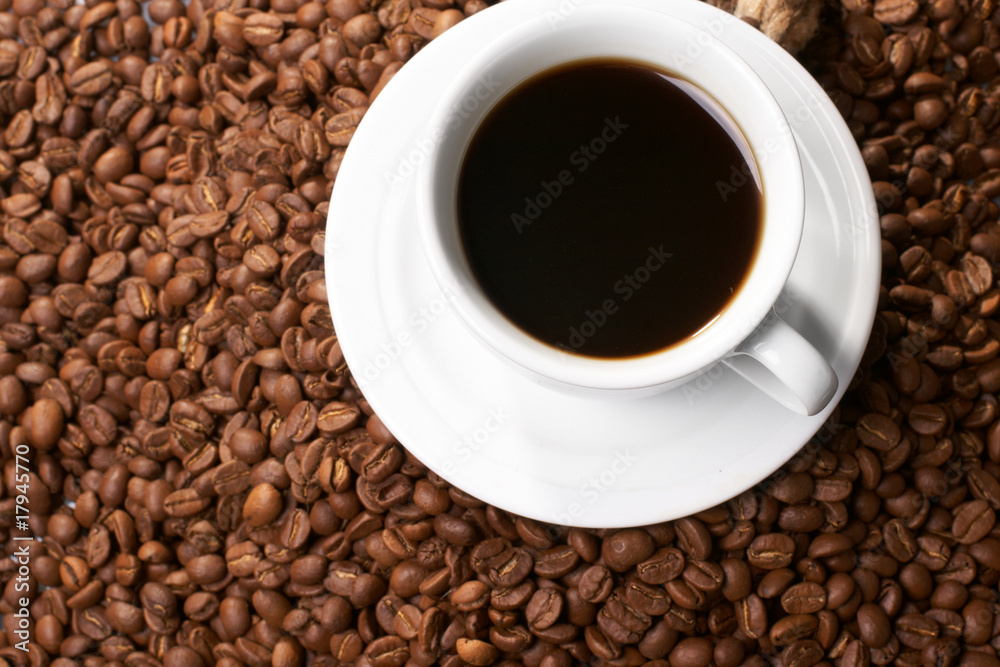 Cup with coffee, costing on coffee grain Cup with coffee, costing on coffee grain