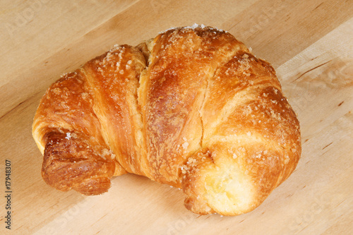 Croissant over wooden background
