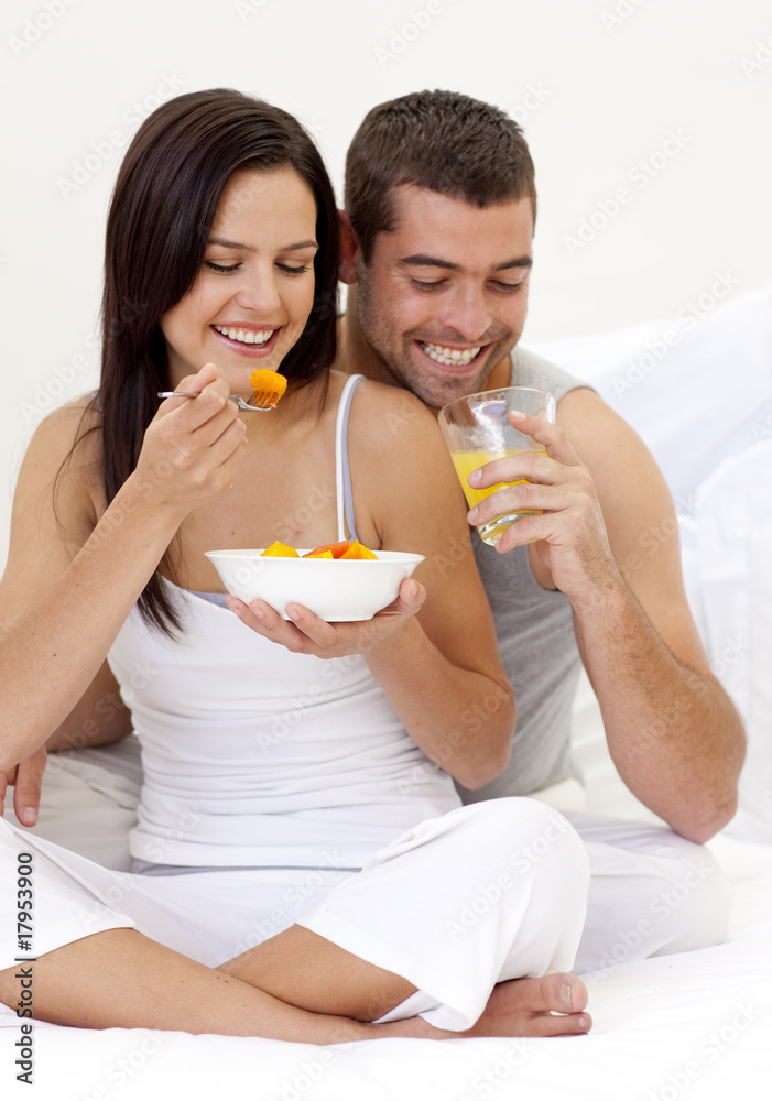 Couple having nutritive breakfast in bed Couple having nutritive breakfast in bed