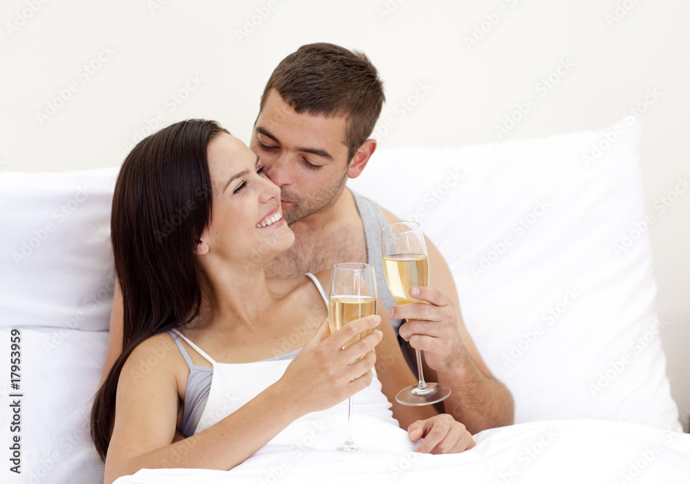Lovers drinking champagne in bed Lovers drinking champagne in bed