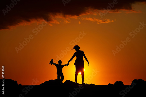 Silhouette of people on the beach at sunset