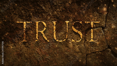 Trust old text over stone with shadows flying and sparkles.