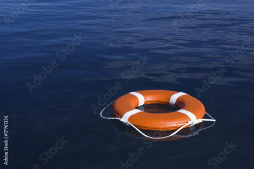 Round life preserver floating in water