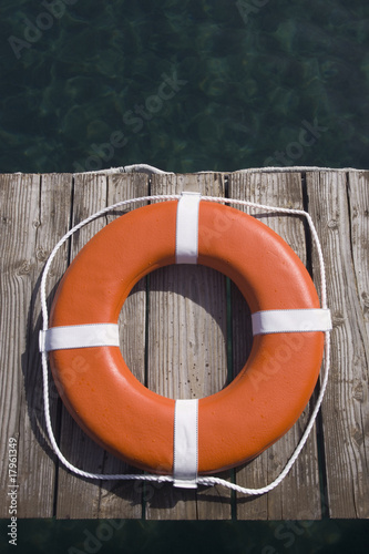 Round life preserver on wooden dock
