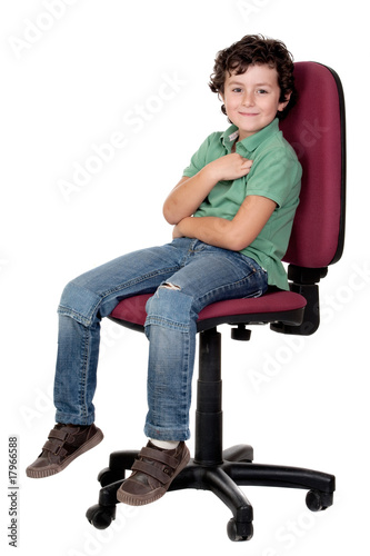 Adorable little boy sitting on big chair