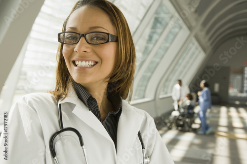 African doctor smiling in corridor