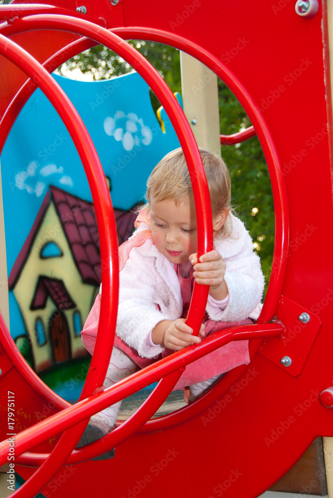 Little girl plays in playground Little girl plays in playground
