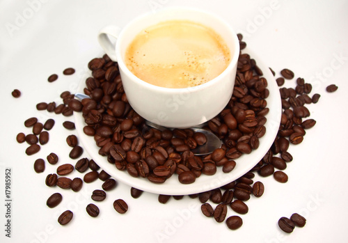 Cup of coffee with coffee beans isolated on white