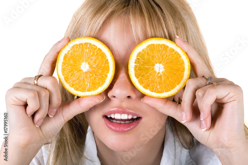 Portrait of the funny young woman with oranges. Isolated