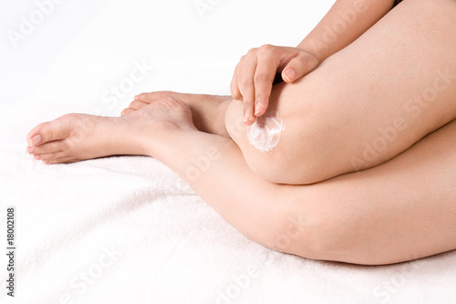 Applying cream to knee