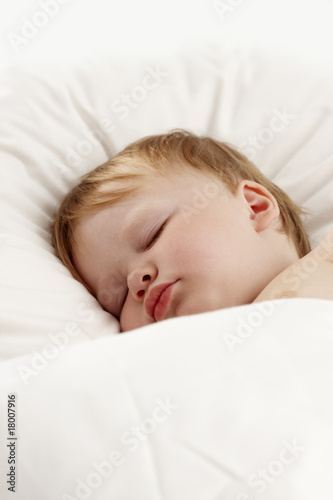 cute baby sleeping in white bed
