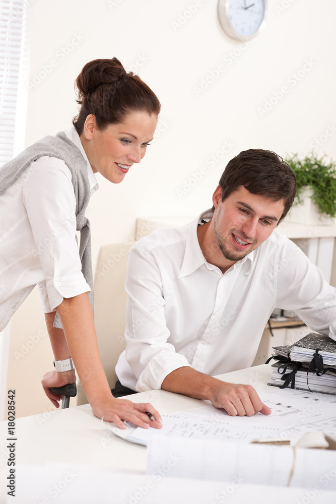 Young man and woman working together Young man and woman working together