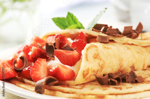 Crepes with curd cheese and strawberries photo