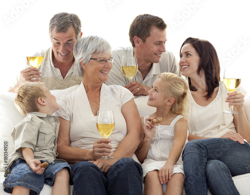 Family drinking wine and children eating biscuits photo