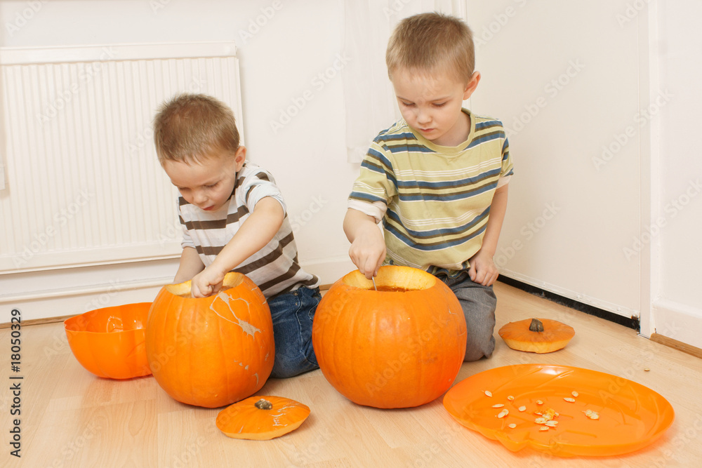 Fototapeta premium boys scooping pumpkins
