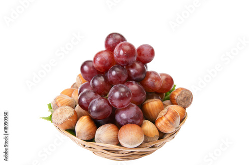 Tasty , ripe hazelnuts and grape isolated on a white background.